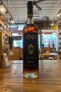 Tall Slim bottle containing bourbon with  long black lable with gold label that says 2XO Inkeeper's Blend