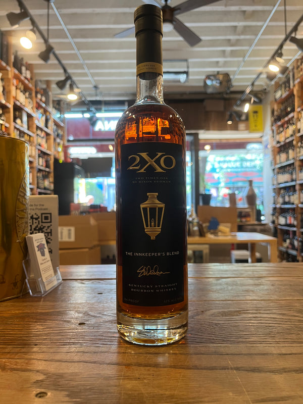 Tall Slim bottle containing bourbon with  long black lable with gold label that says 2XO Inkeeper's Blend