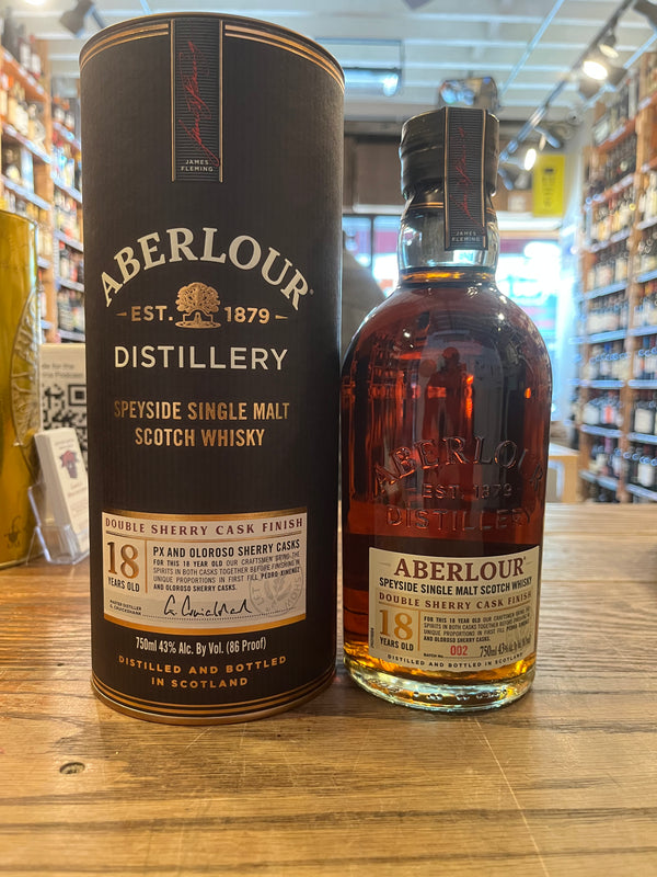 Short fat bottle with beige label with red lettering that says Aberlour Double sherry cask finish, gold lettering that says 18 years old, and it's round brown gift tin that reads Aberlour Double sherry cask finish