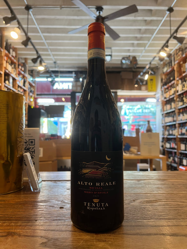 Alto Reale Nero d'Avola 750mL Black bottle with low wide shoulders with red top and black label reading Alto Reale Tenuta Rapitala Nera D' Avola