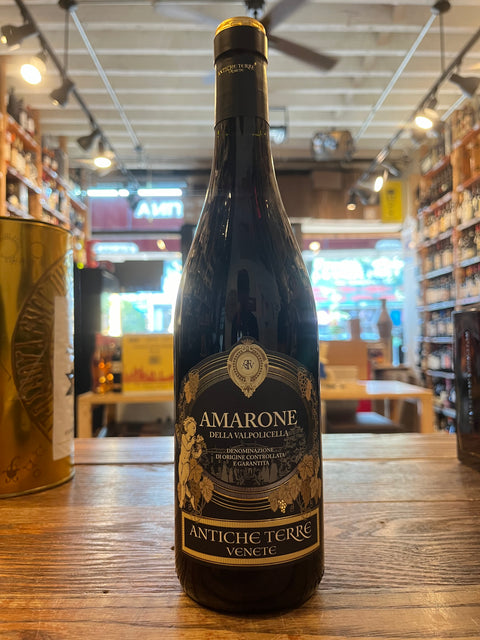 Antiche Terre Amarone, black bottle with low shoulders and black label depicting cherubs and gold embellishments 