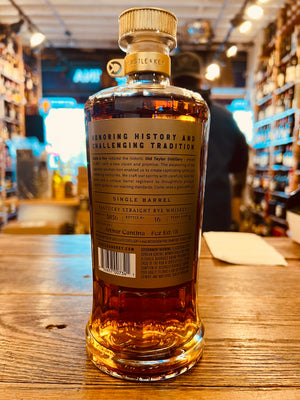 Castle & Key Restoration Rye Single Barrel Whiskey Private Select 750mL the back of a wide shouldered clear bottle with a golden label and a golden top