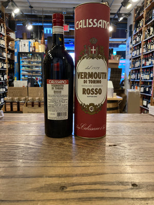 Luigi Calissano Rosso Vermouth di Torino Superiore 750mL the backside of a dark glass bottle with a white label next to a red cylinder tin canister  