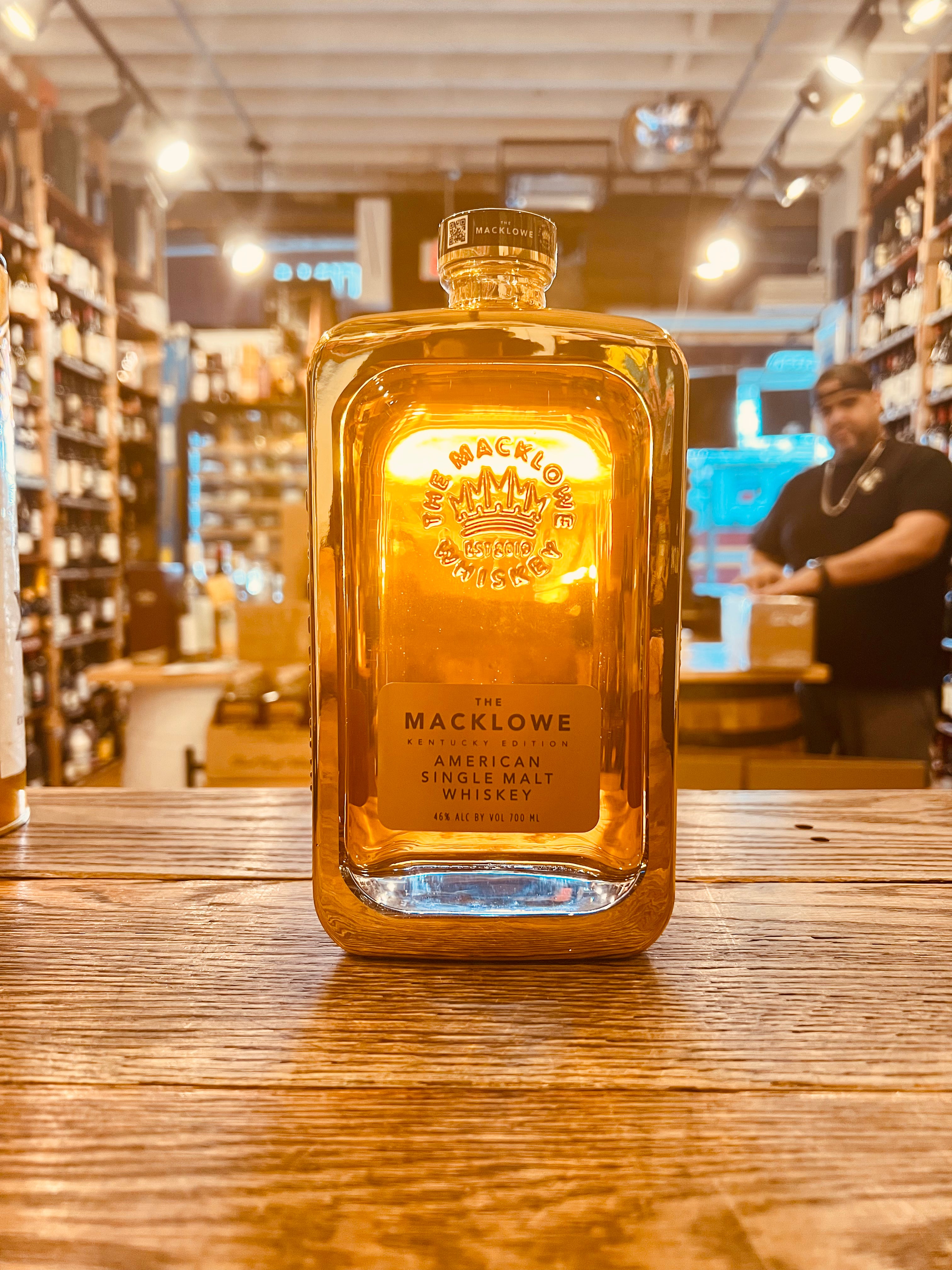 The Macklowe Gold Kentucky Edition 700ml a squared clear glass bottle with a short stubby neck with a golden cast around the glass bottle and a golden label