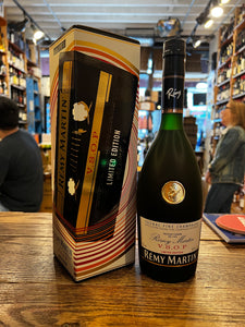 Remy Martin VSOP Limited Edition Volume 2 700mL a tall rectangular shaped box white and black in color next to a dark green elegantly shaped glass bottle with a white and black label and golden emblem and black top