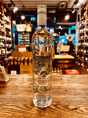 Superbird Blanco 750ml Tequila the backside of a tall slender clear glass bottle with a silver top