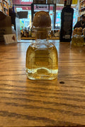 Patron Anejo 100mL clear bottle with cork on top.
