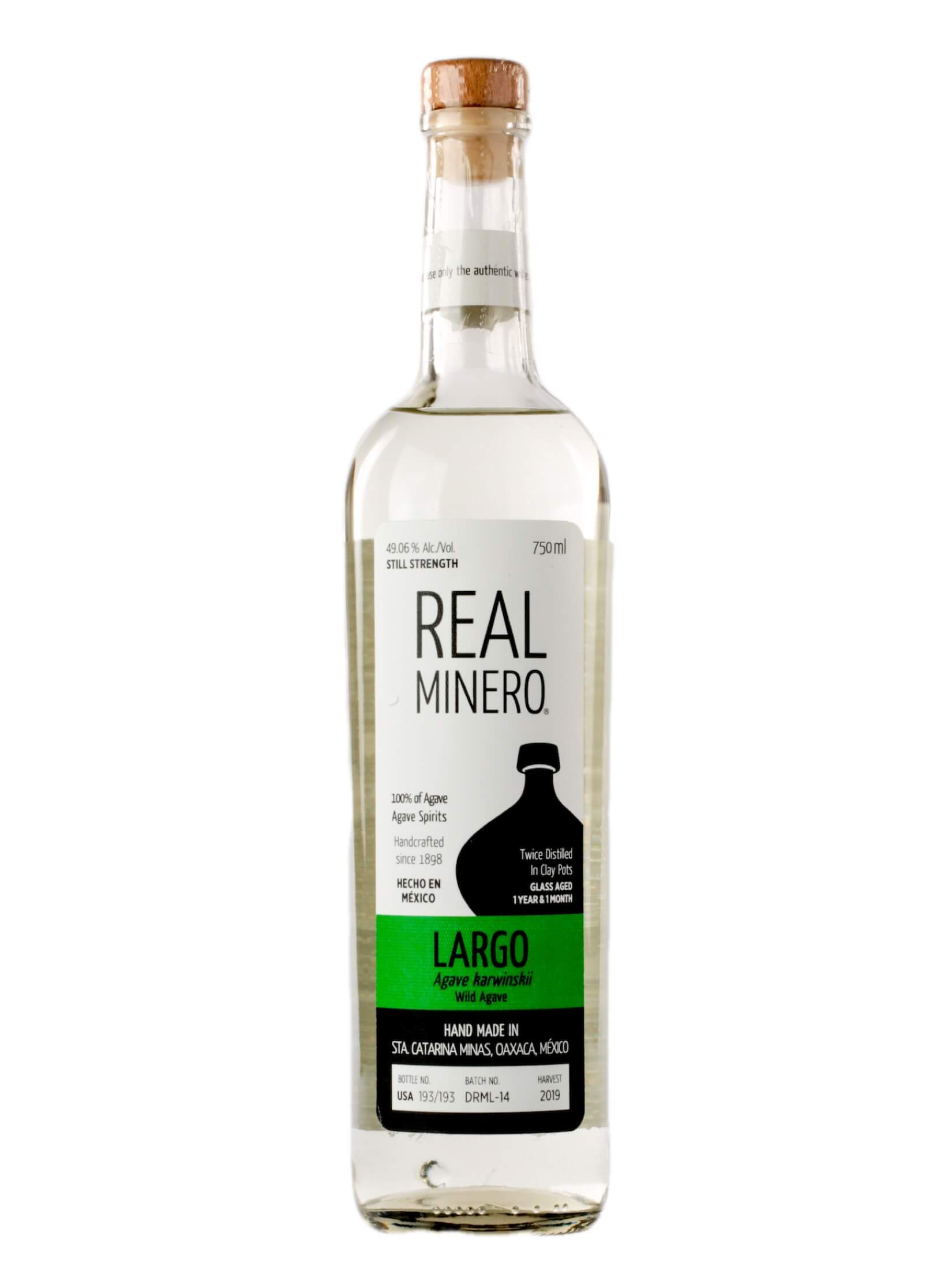 Real Minero Largo 750mL a tall slender clear glass bottle with a white and green label with a wooden top