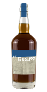 Guero 6YR Bourbon 750mL a rounded high shouldered  clear bottle with a blue and gray label 