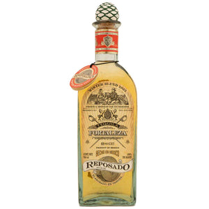 Fortaleza Winter Blend Barrel Proof 750mL 2023 a tall flat round shouldered clear bottle with a beige label and an orange label around the neck topped with a wooden agave plant