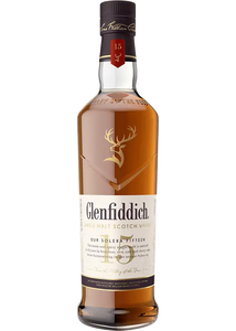 Glenfiddich Sing Malt Scotch 15 year tall angulated clear bottle with a white label and a golden deer emblem  