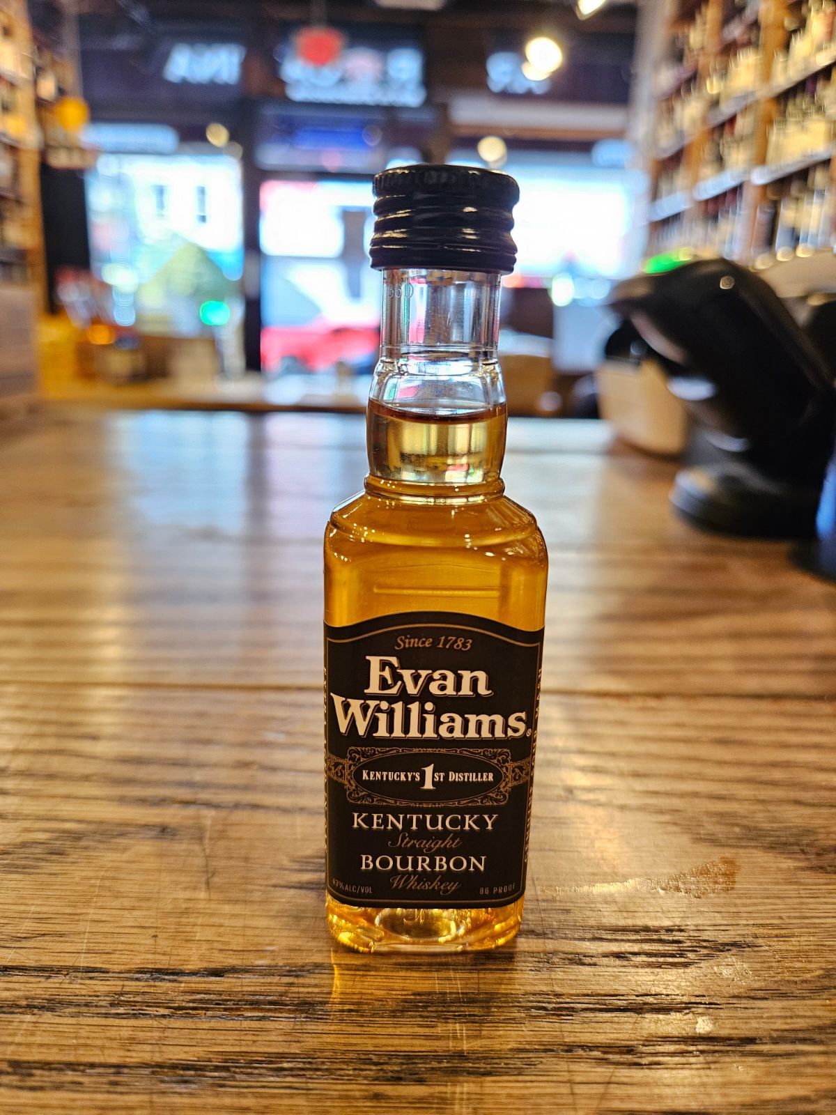 Evan Williams Bourbon 50mL small clear bottle with a black label and black top
