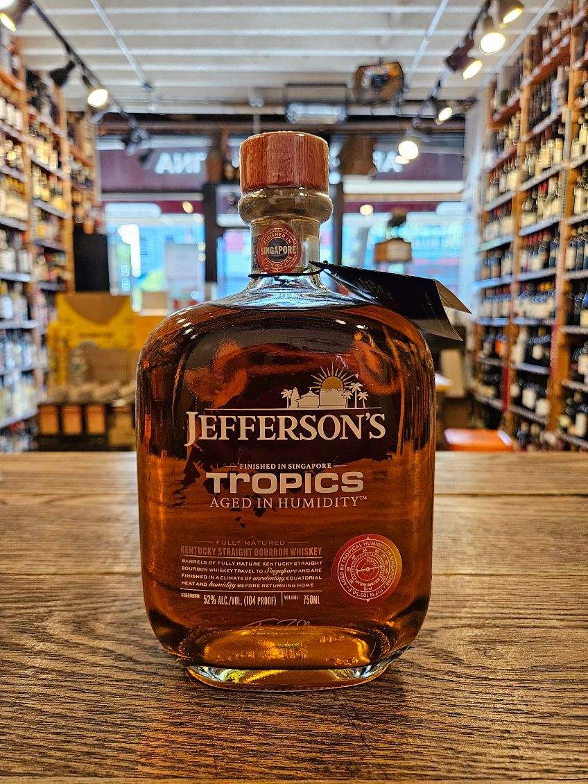 Jefferson's Tropics Aged in Humidity 750mL a short square rounded clear glass bottle with white lettering and a wooden top