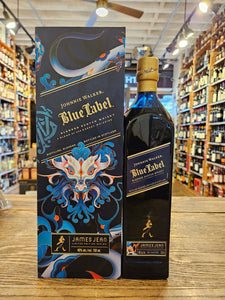 Johnnie Walker Blue Label James Jean Limited Edition Design a large blue box with a colorful dragon design next to a tall slender blue glass bottle with a blue label and golden top