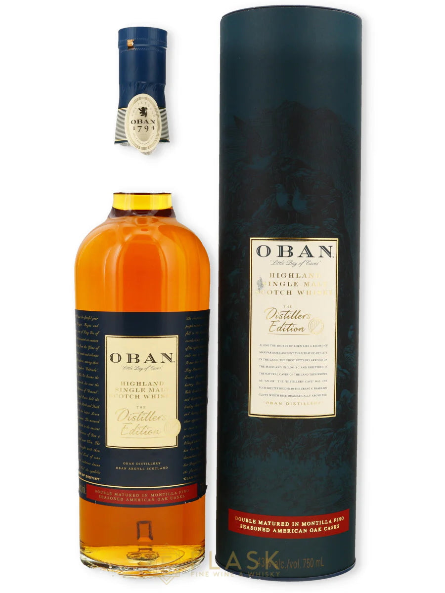 Oban The Distiller's Edition 750mL a tall clear glass bottle with a dark blue and tan label next to a tall dark blue tin cylinder