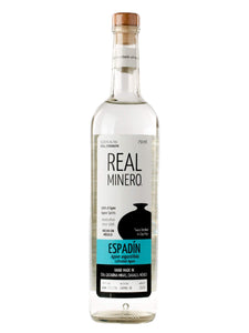 Real Minero Espadin 750mL a tall slender clear glass bottle with a white and light blue label and a wooden top
