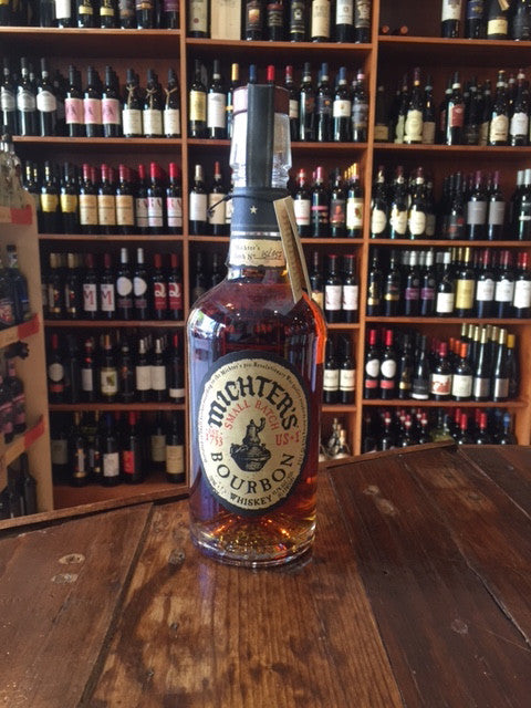 Michter's Bourbon Small Batch 750mL a clear round shouldered glass bottle with a beige label and wooden top