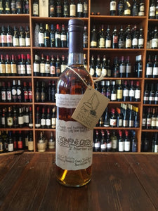 Rowan's Creek Bourbon Kentucky 750ml 100.1º a tall clear glass wine shaped bottle with a beige label and black top