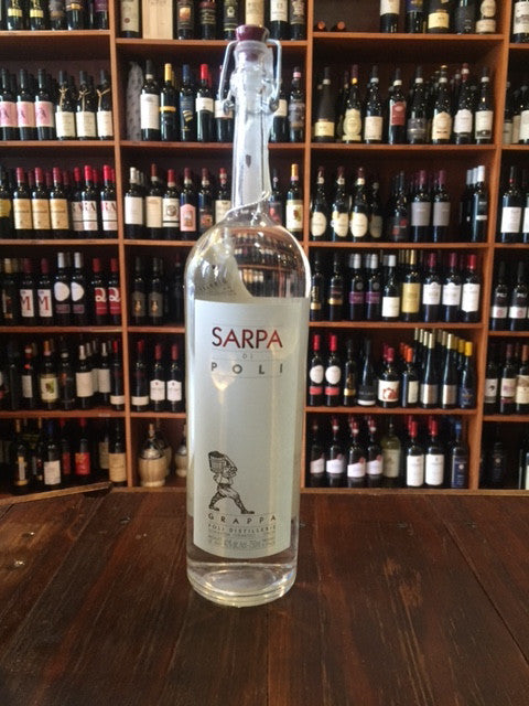 Sarpa di Poli Grappa 750mL a tall slender necked clear glass bottle with a white label and a pop topper