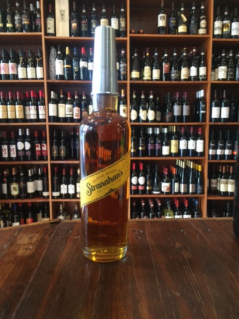 Stranahan's Colorado Whiskey 750ml a tall high shouldered clear glass bottle with a yellow label and a metal shot glass topper