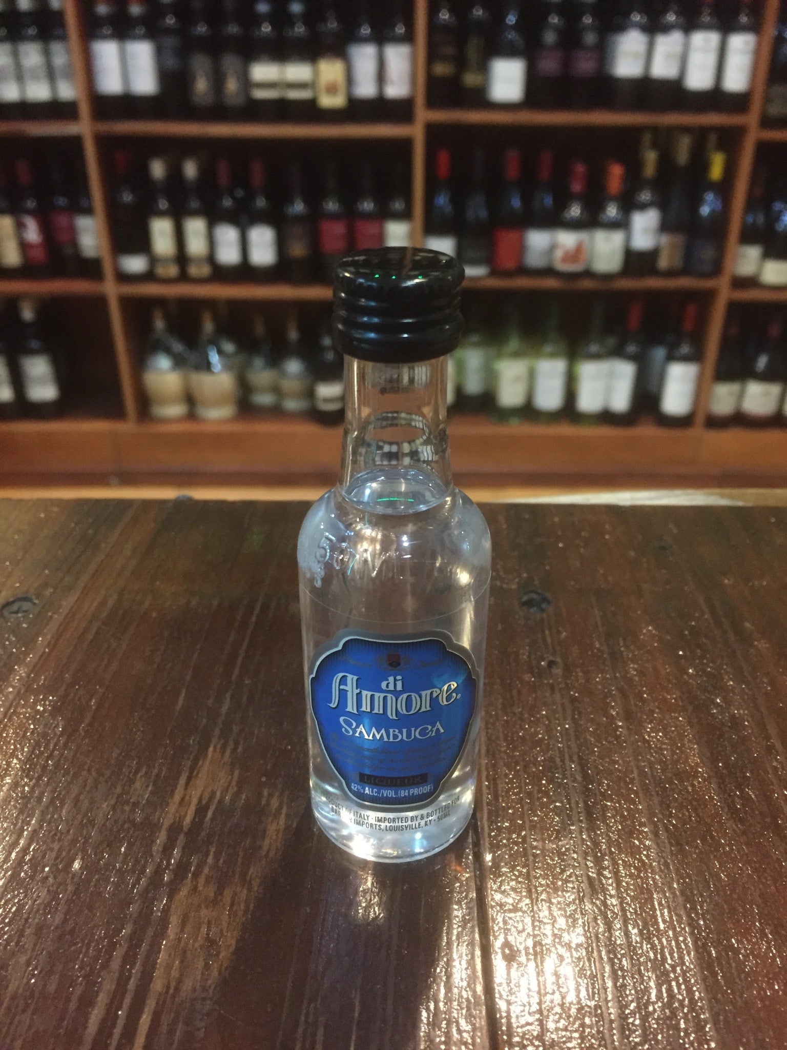 Di Amore Sambuca 50mL small clear bottle with a blue label and black top
