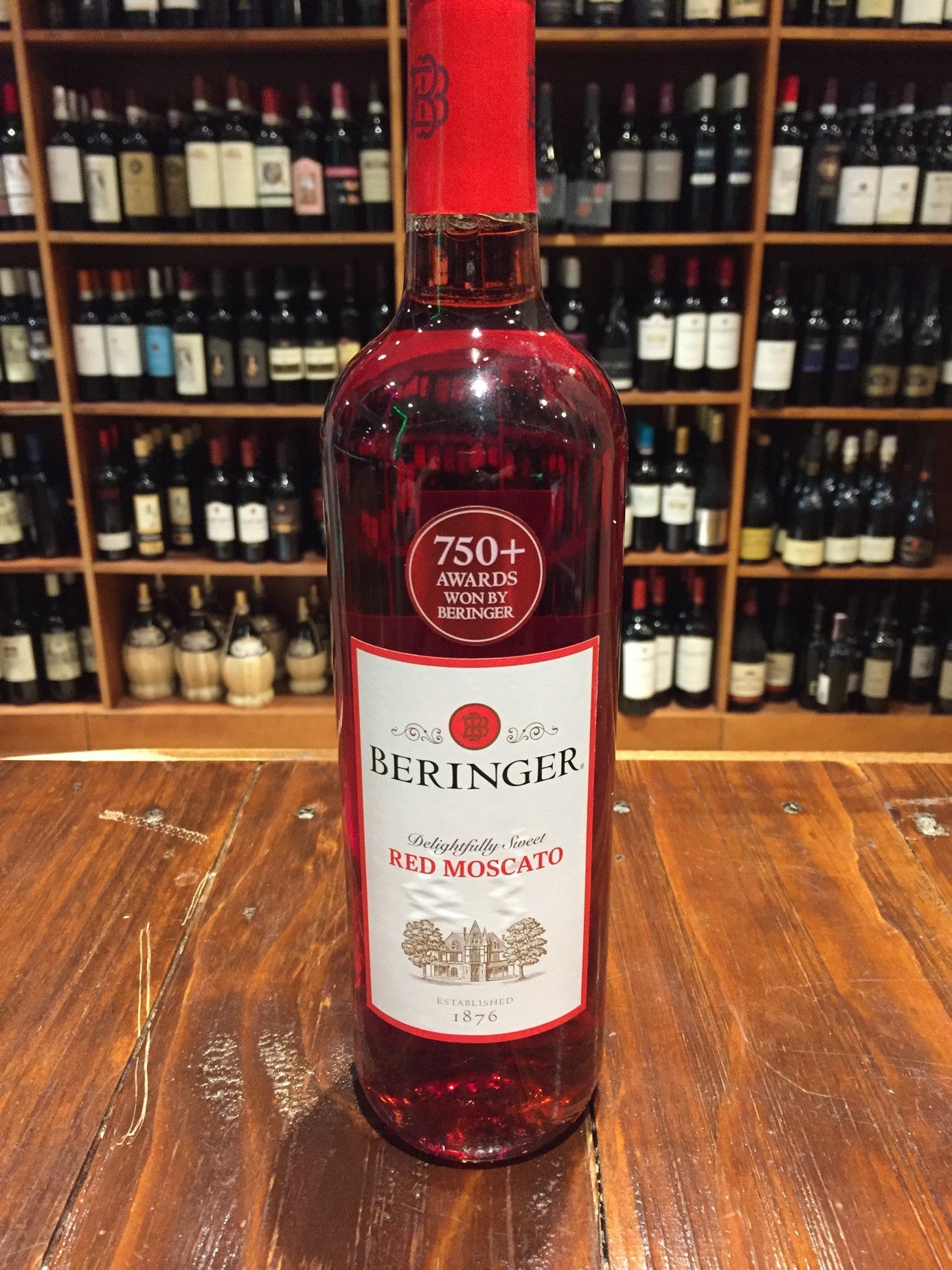 Beringer Red Moscato 750ml clear bottle with red liquid and a white label