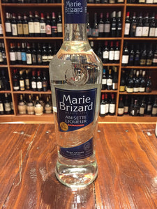 Marie Brizard Anisette 750mL a tall clear glass bottle with a blue label and blue top