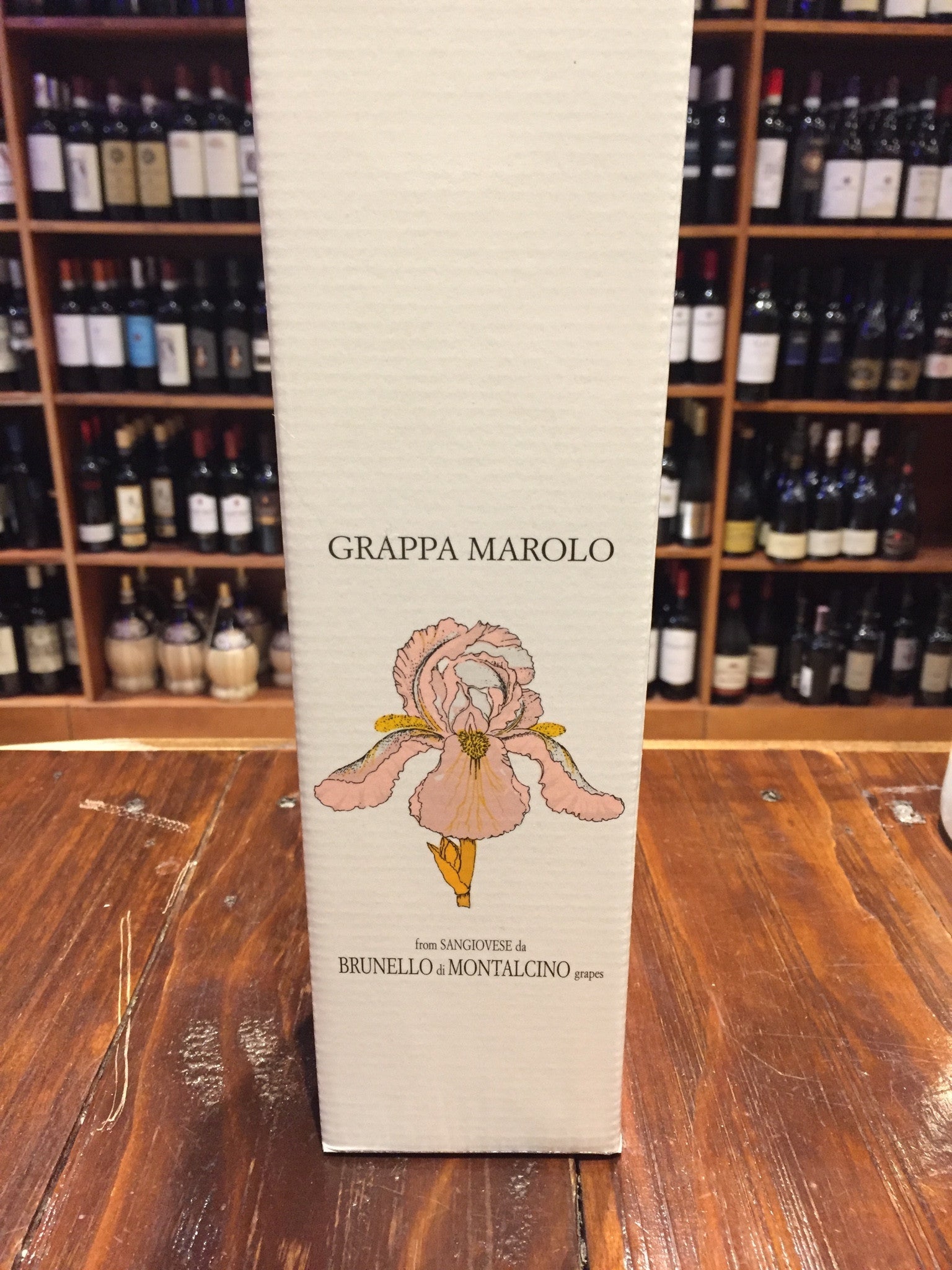 Marolo Grappa Brunello 750ml a white tall squared box with the image of a flower on it