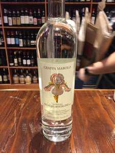 Marolo Grappa Brunello 750ml clear glass bottle with a beige label with an image of a flower on it