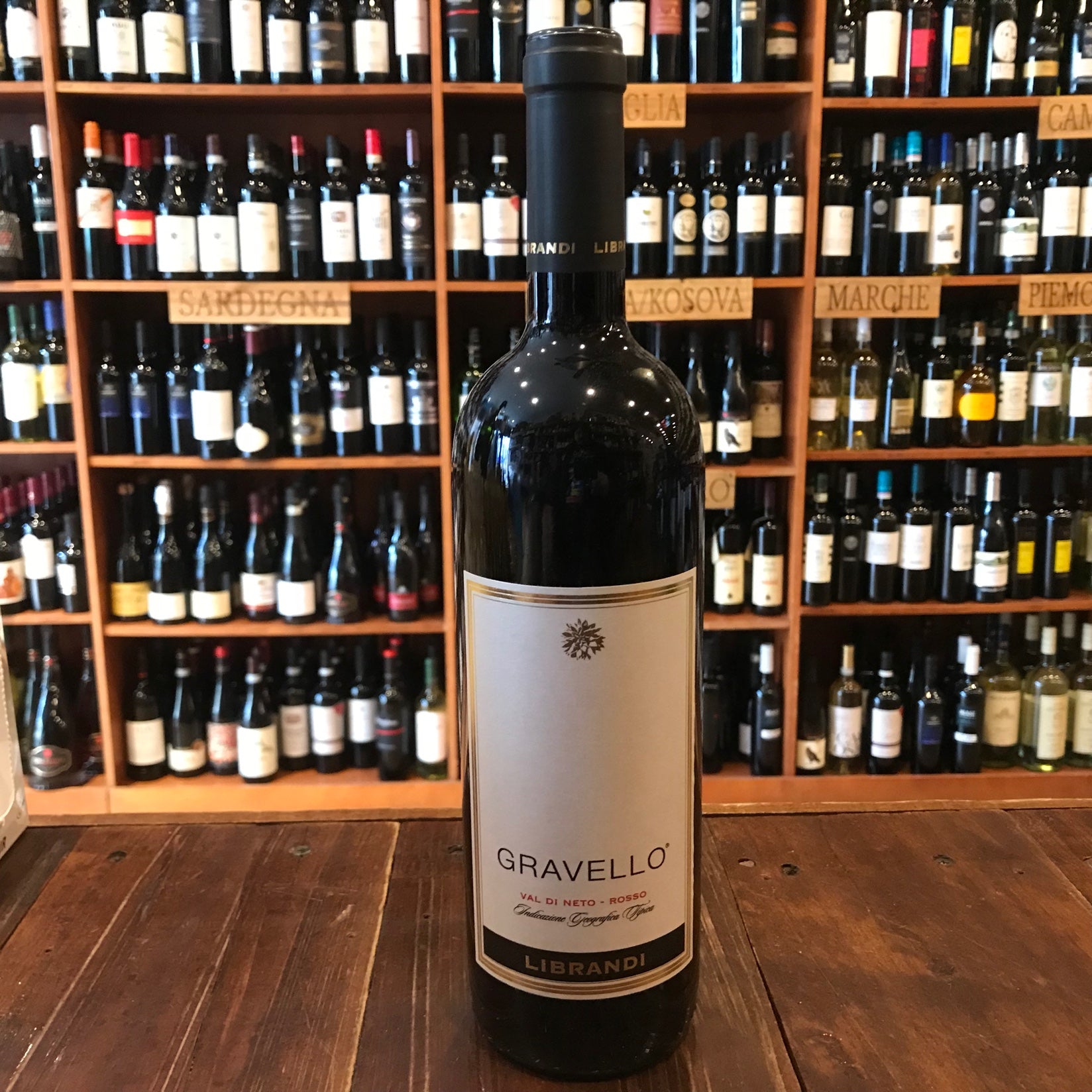 Librandi Gravello 750mL 2017 a tall dark glass wine bottle with a white label and a dark top