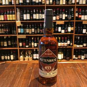 Rittenhouse Rye 750ml Bonded 100º a high shouldered clear glass bottle with a maroon and black label with a black top