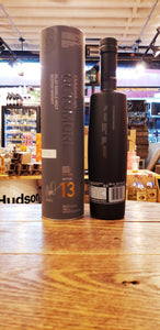 Octomore 13.1 118.4 750mL a tall gray cylinder next to a tall round shouldered slender black frosted glass bottle 