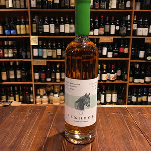 Pinhook Hard Rye Guy Whiskey 750mL a tall clear glass bottle with a long slender neck with a white and green label and a green waxed top