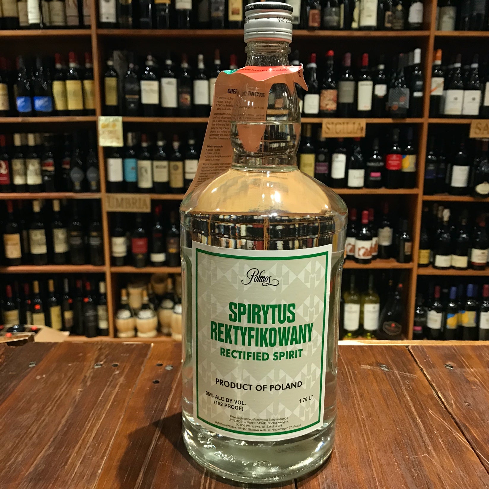 Polmos Spirytus Rektyfikowany 192º 1.75L a large clear glass bottle with a green and white label and silver top