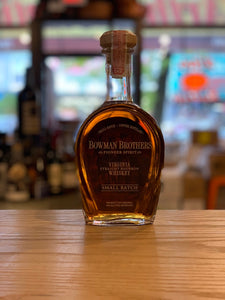 Bowman Brothers Small Batch 750mL a rounded squat clear bottle with yellow lettering and a wooden top