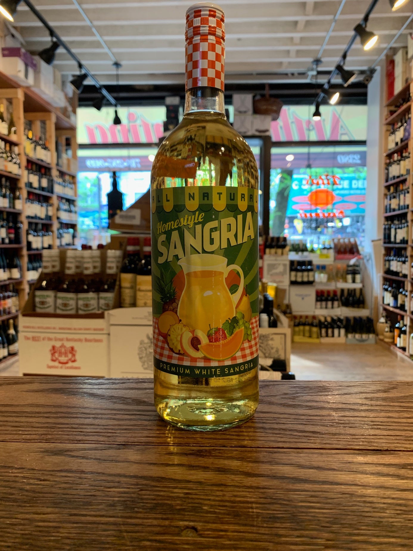 Homestyle White Sangria 1L a tall high shouldered clear glass bottle with a green label and checkered top