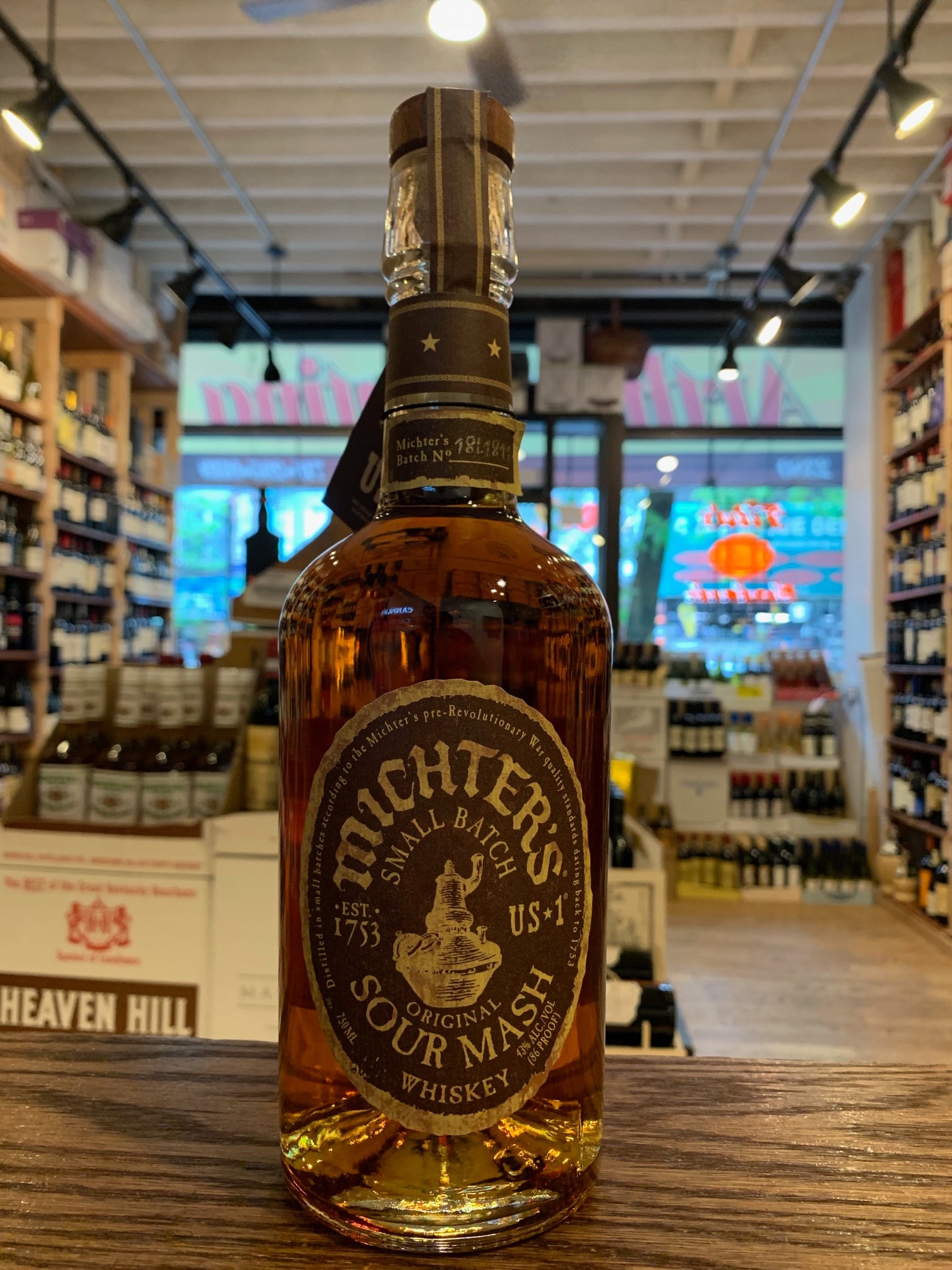 Michter's Sour Mash 750mL a high rounded shouldered clear glass bottle with a brown label and a wooden top