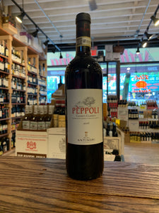 Peppoli Chianti Classico 750mL a dark glass wine bottle with a white label and black top
