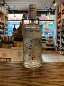 The Botanist Islay Dry Gin 750mL a rounded shouldered clear glass bottle with etched on design and a white label with a white top