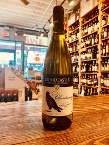 Stone Castle Chardonnay Reserve 750ml Kosovo a tapered straw colored glass wine bottle with a white and black label and the image of a hawk on it with a black top