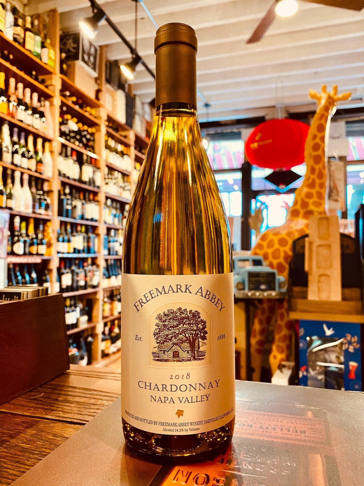 Freemark Abbey Chardonnay 750mL a clear wine bottle with a beige label with an image of a house with a brown top