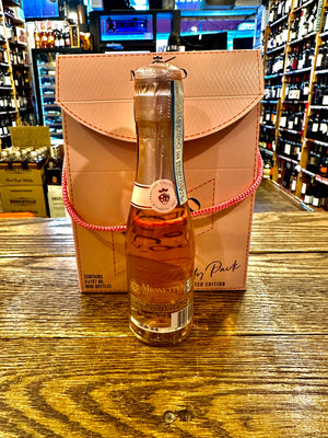 Mionetto Prosecco Rose 187mL the backside of a small clear glass champagne bottle with a pink label and a pink top, displayed in front a of small pink box