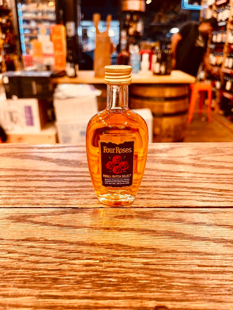 Four Roses Small Batch Select 50mL a small clear round flat bottle with a brown label and golden top