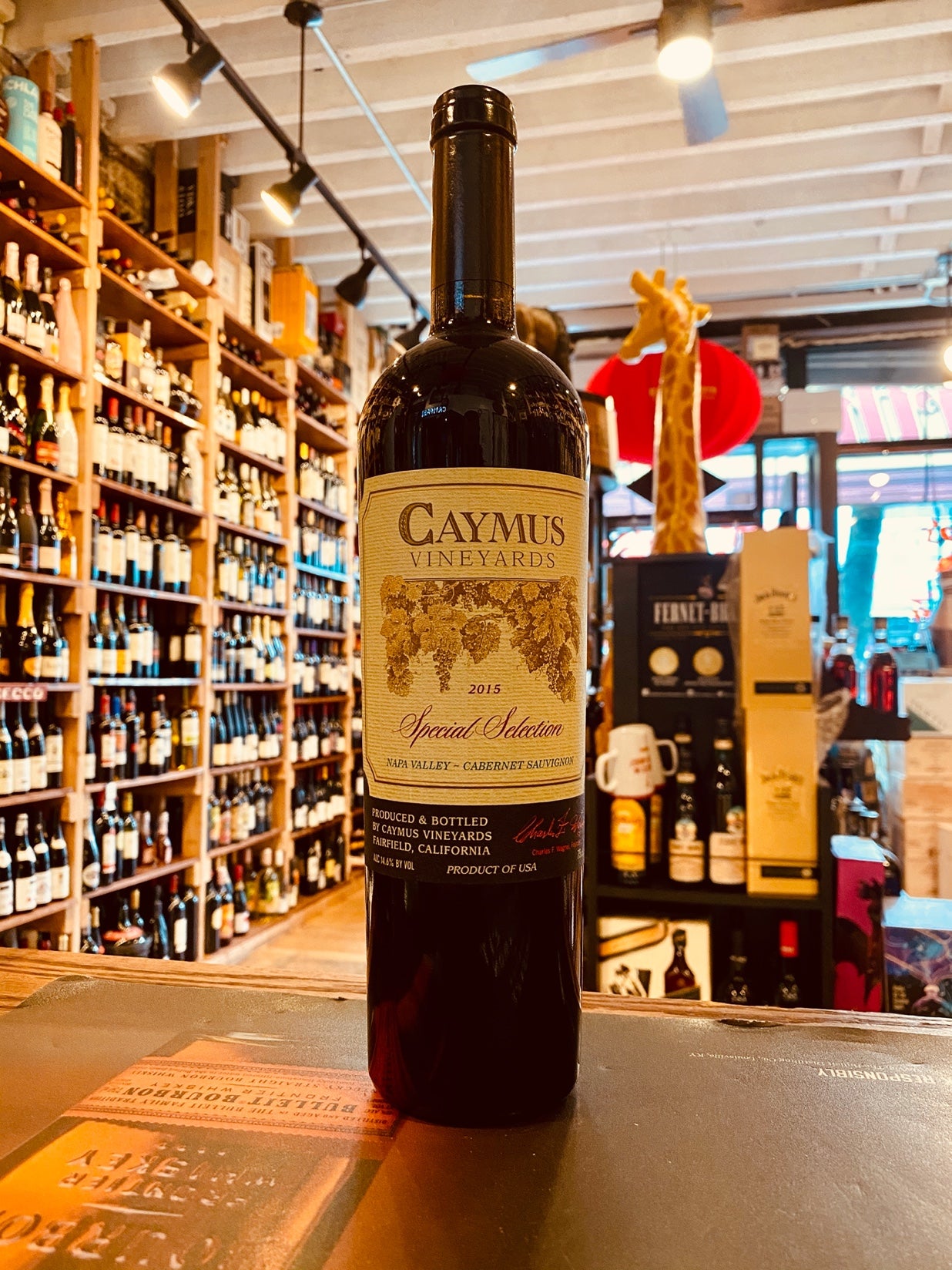 Caymus Special Selection 750mL dark wine bottle with a light green label and black top