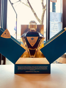 Stone Castle 25yr Verak 750mL a blue box split open with a diamond shaped clear glass bottle inside with gold backing and a gold label and glass diamond shaped topper