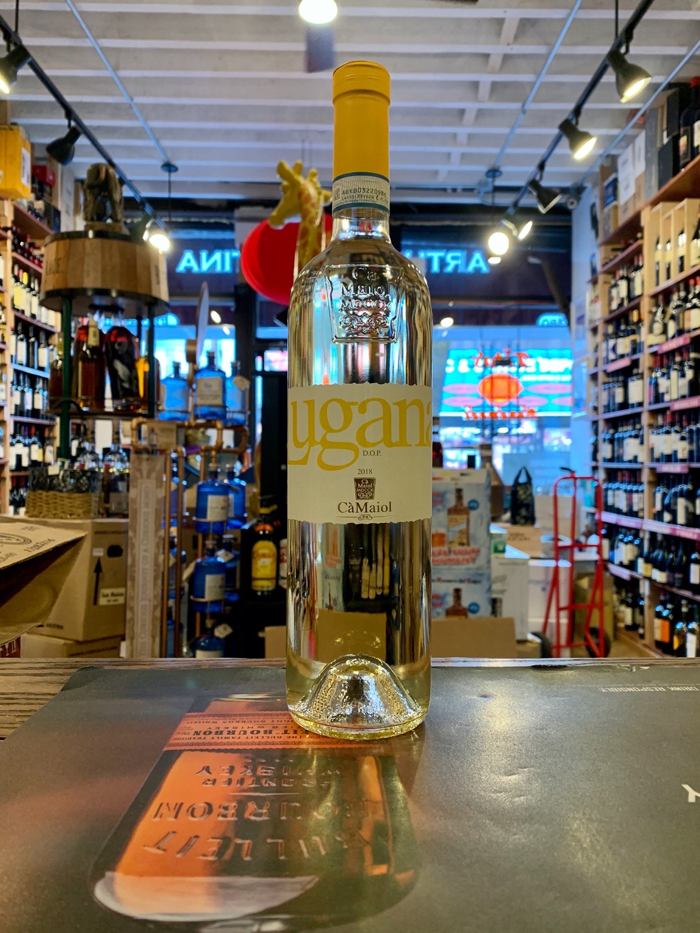Ca'Maiol Lugana 2018 750mL a clear slender wine bottle with a white and yellow label and yellow top