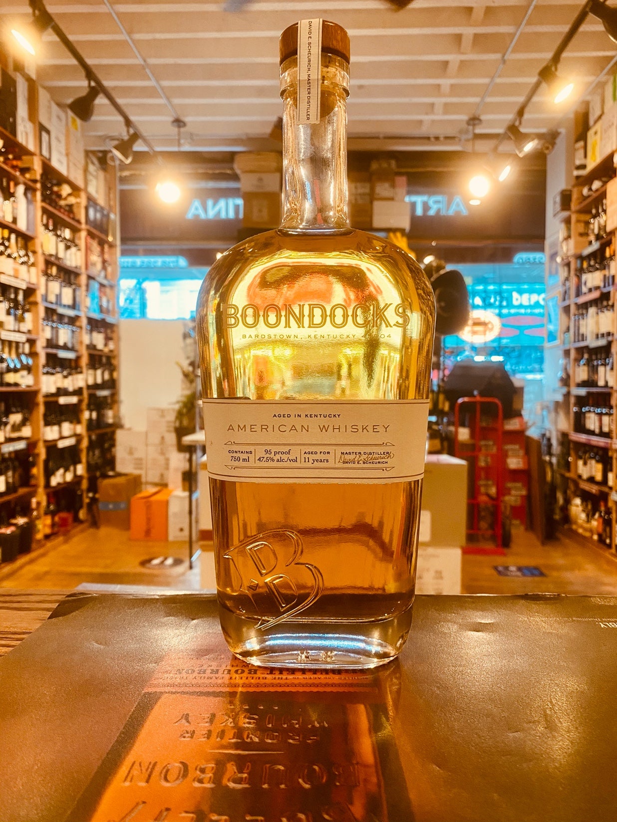 Boondocks American Whiskey 750ml 11yr old tall flat rounded clear bottle with a white label.