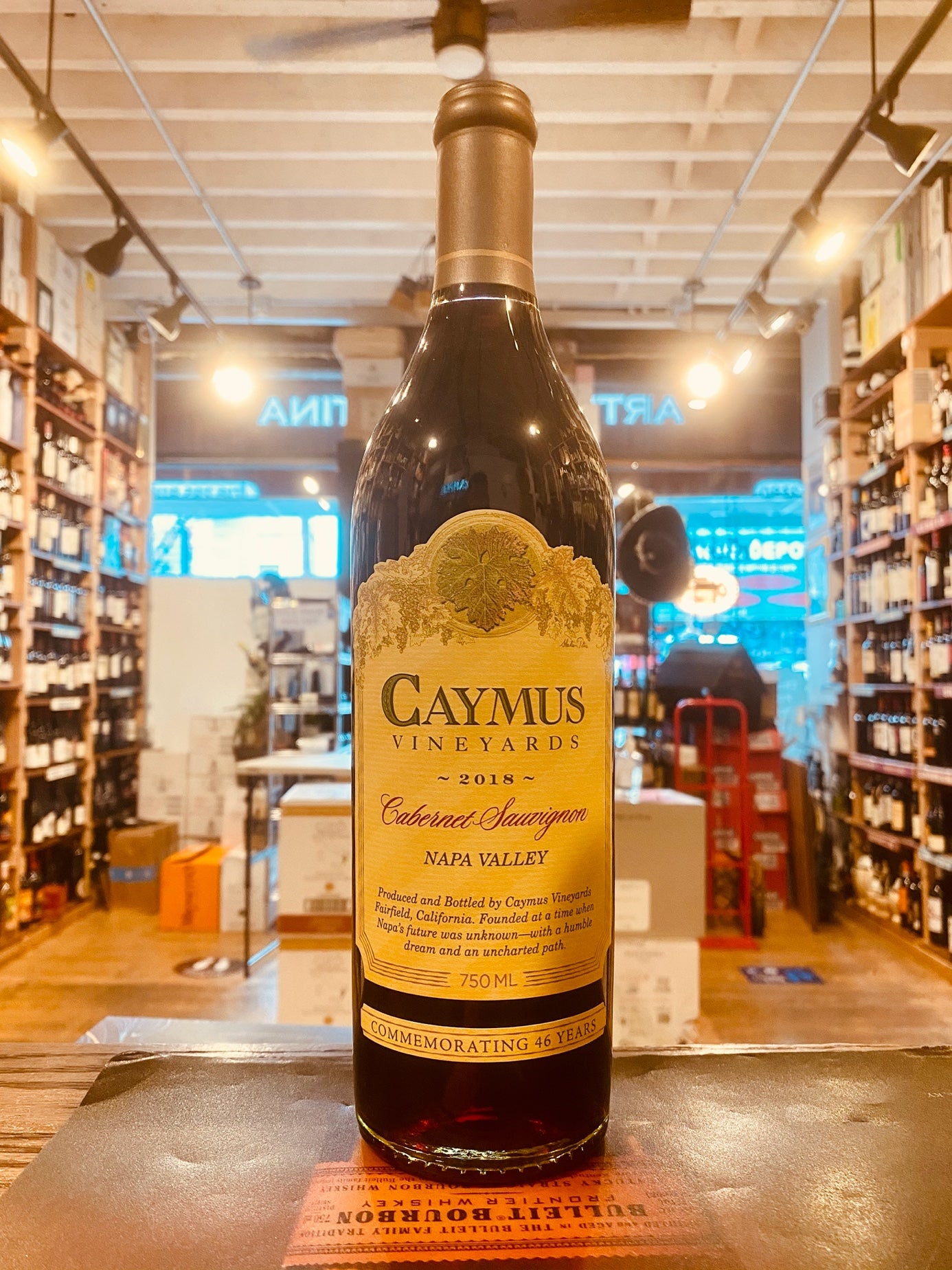 Caymus Cabernet Napa 750mL tall stubby necked dark bottle with a yellow label and a silver top