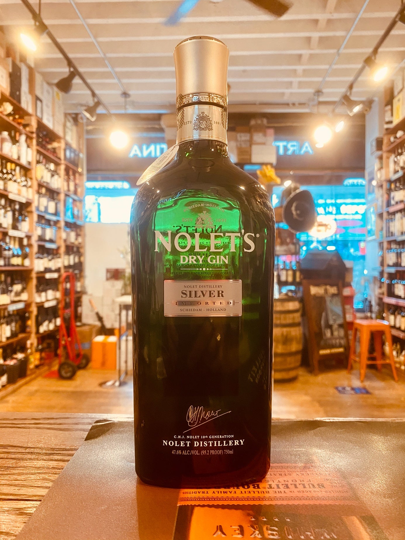 Nolet's Silver Dry Gin 750mL a squared off clear green glass bottle with a white label and silver top