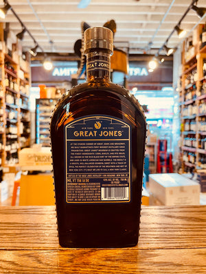 Great Jones Bourbon 750mL NY the backside of a flat rounded shouldered bottle with a short neck blue and gold labeling